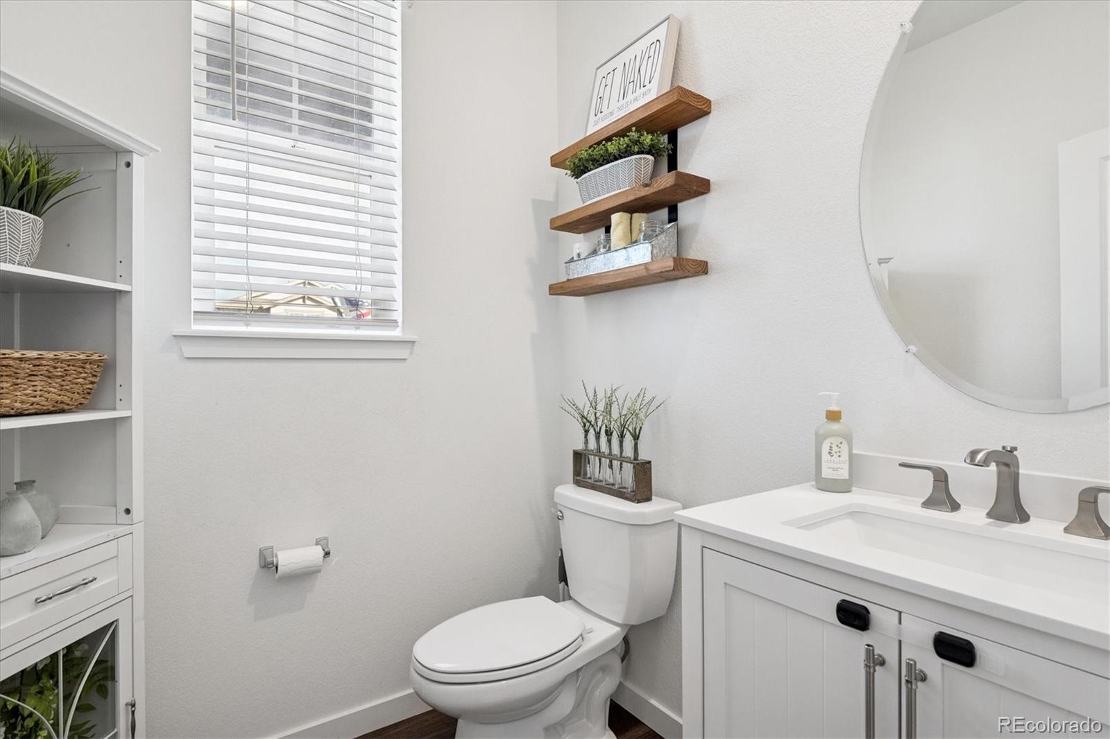 3530 Sawtooth Street Frederick, CO 80516 - Photo 14 of 36 a bathroom with a sink a toilet and a window