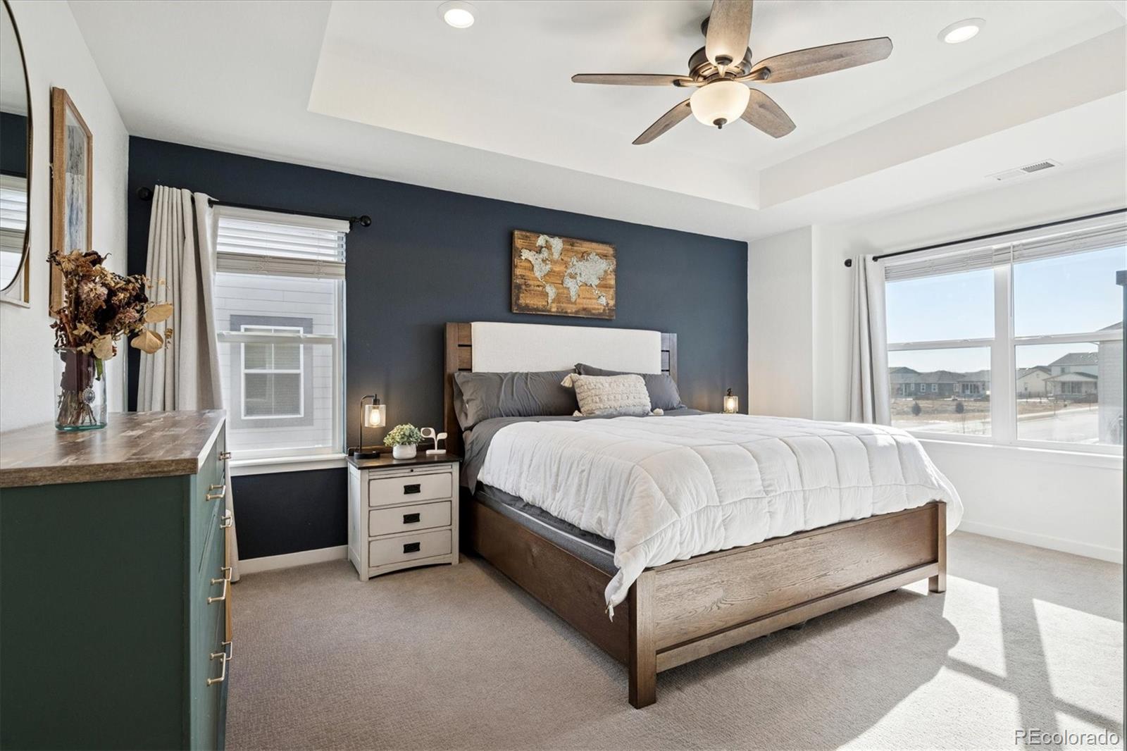 3530 Sawtooth Street Frederick, CO 80516 - Photo 15 of 36 a spacious bedroom with a bed and a chandelier
