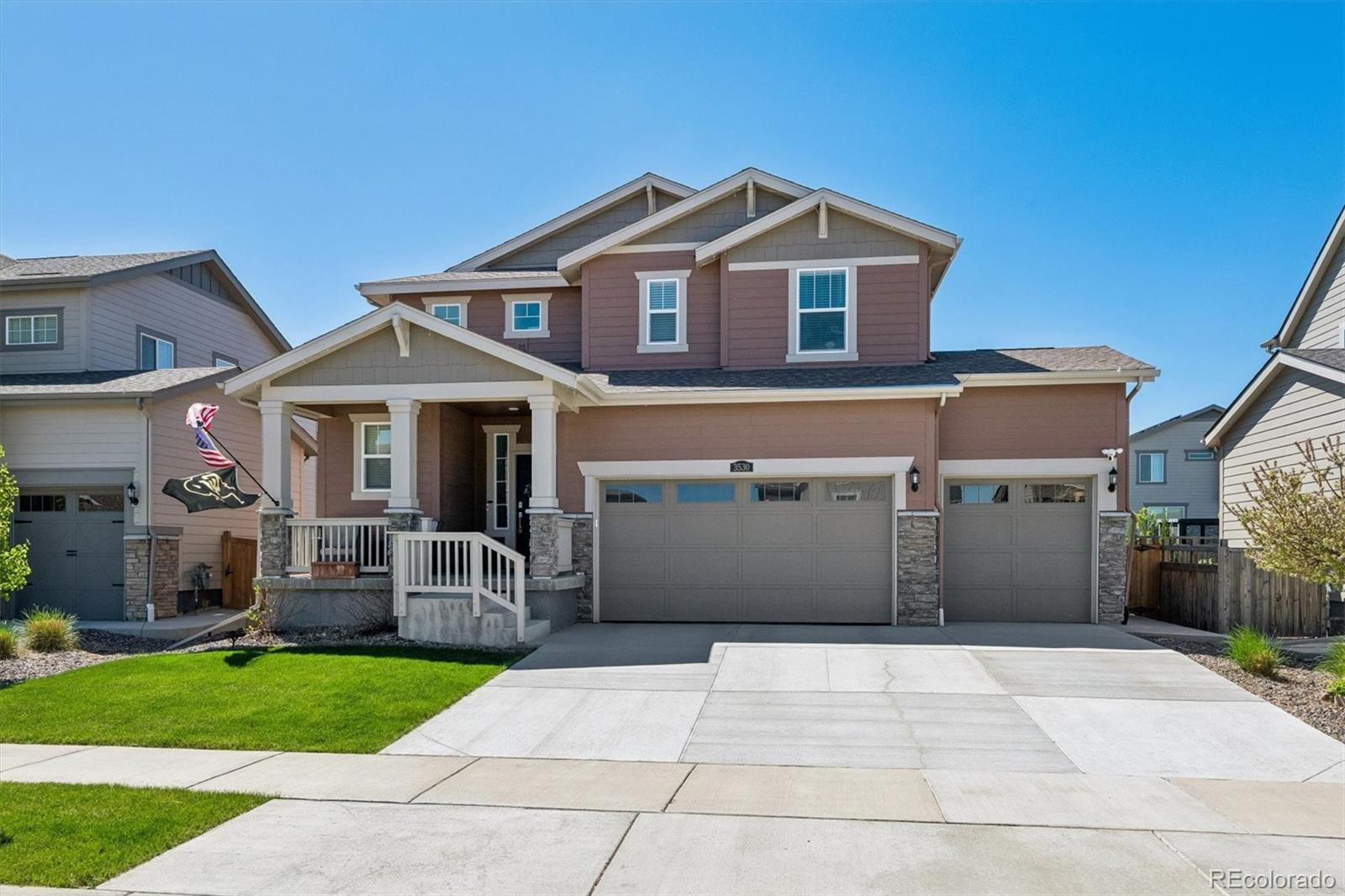 3530 Sawtooth Street Frederick, CO 80516 - Photo 2 of 36 a front view of a house with a yard and a garage