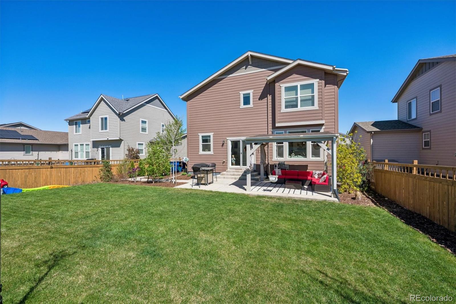 3530 Sawtooth Street Frederick, CO 80516 - Photo 25 of 36 a view of a house with a patio and a yard