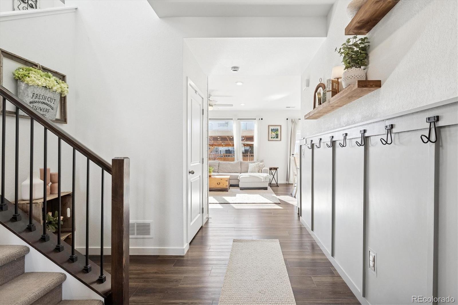 3530 Sawtooth Street Frederick, CO 80516 - Photo 4 of 36 a view of a hallway with wooden floor windows and entryway