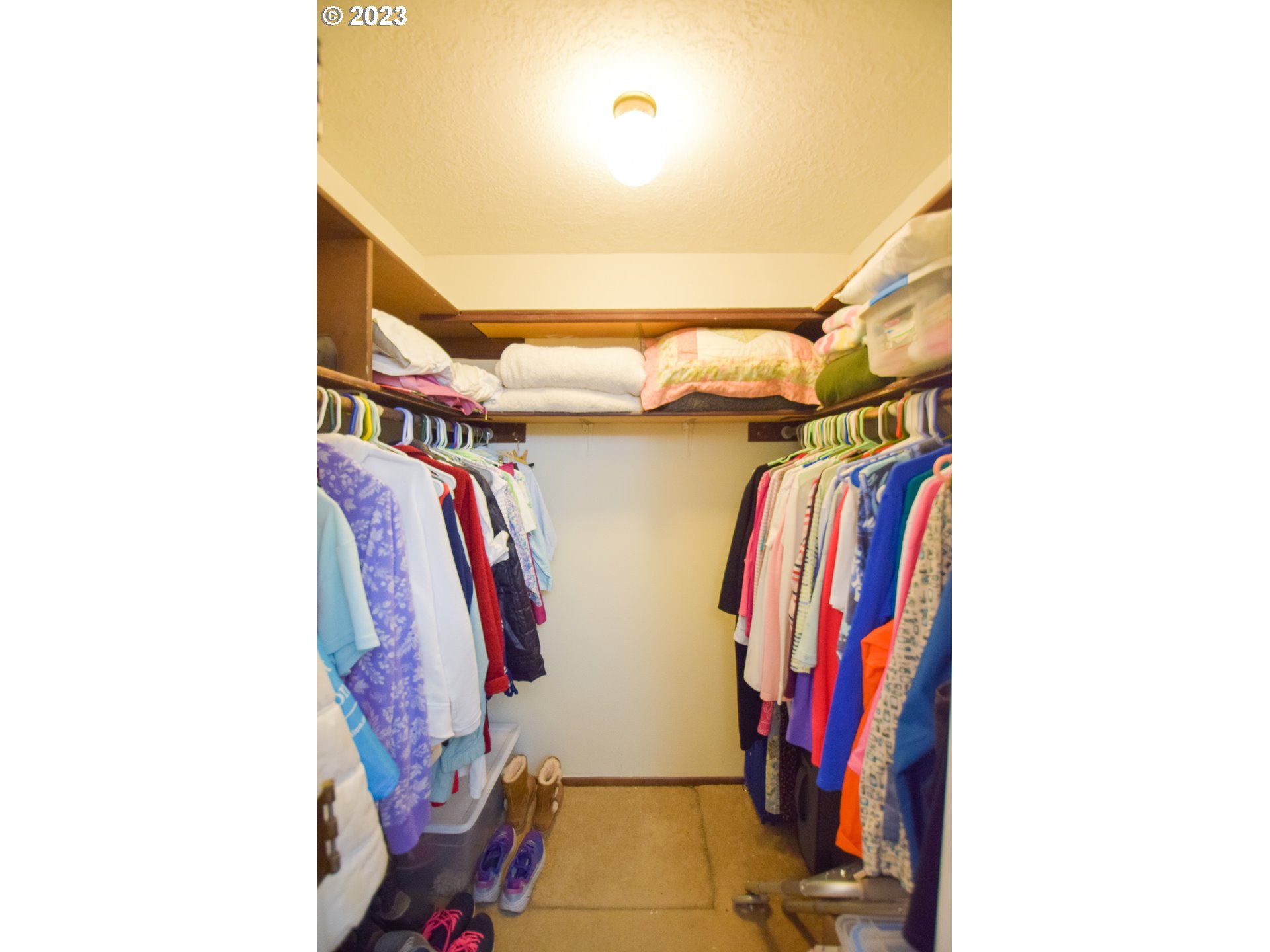 950 Evergreen Road, Unit 122 Woodburn, OR 97071 - Photo 12 of 20 a view of walk in closet with clothes and shoes
