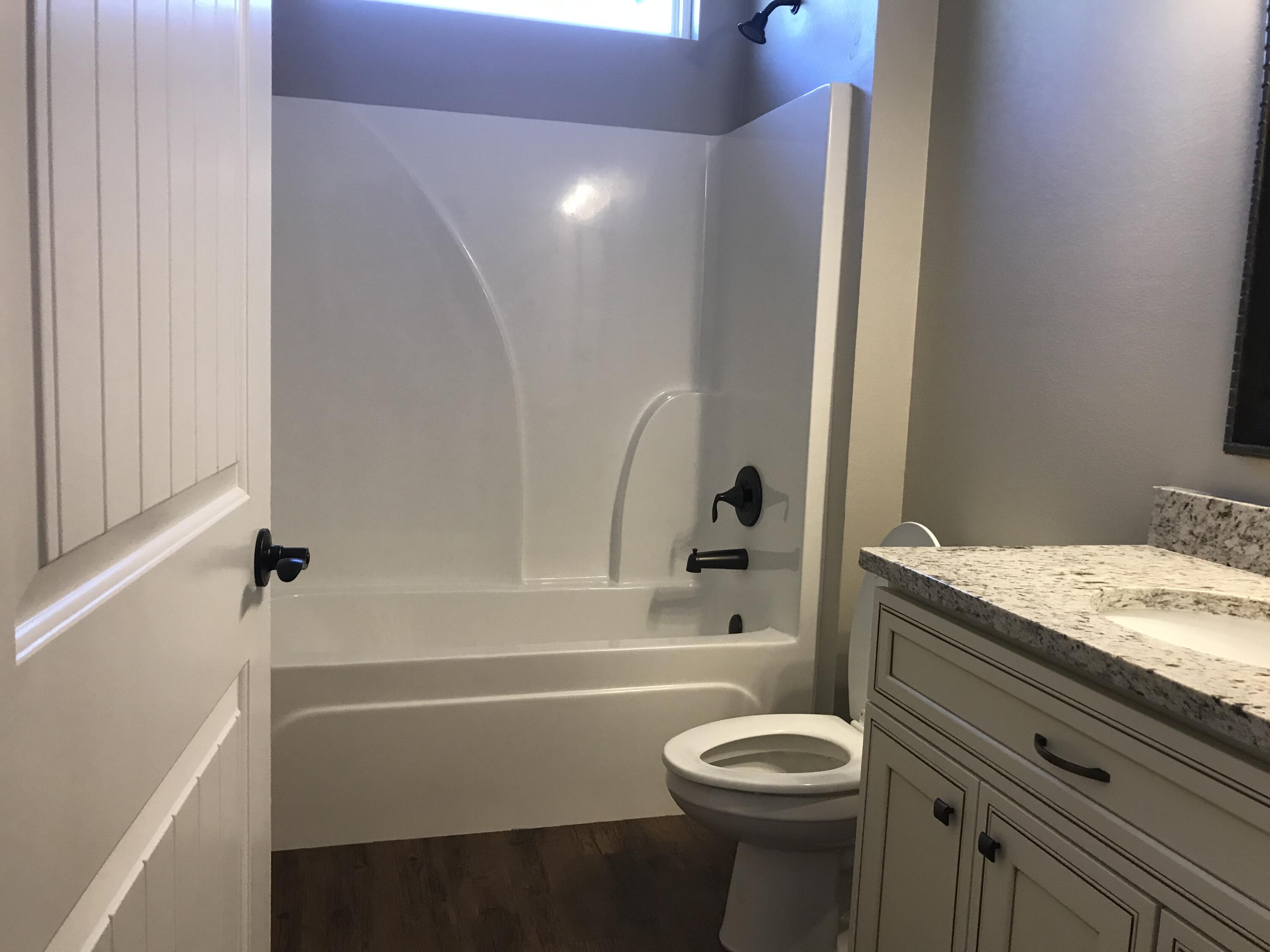 240 Dixie Street Crestview, FL 32536 - Photo 14 of 20 a bathroom with a sink toilet vanity and bathtub