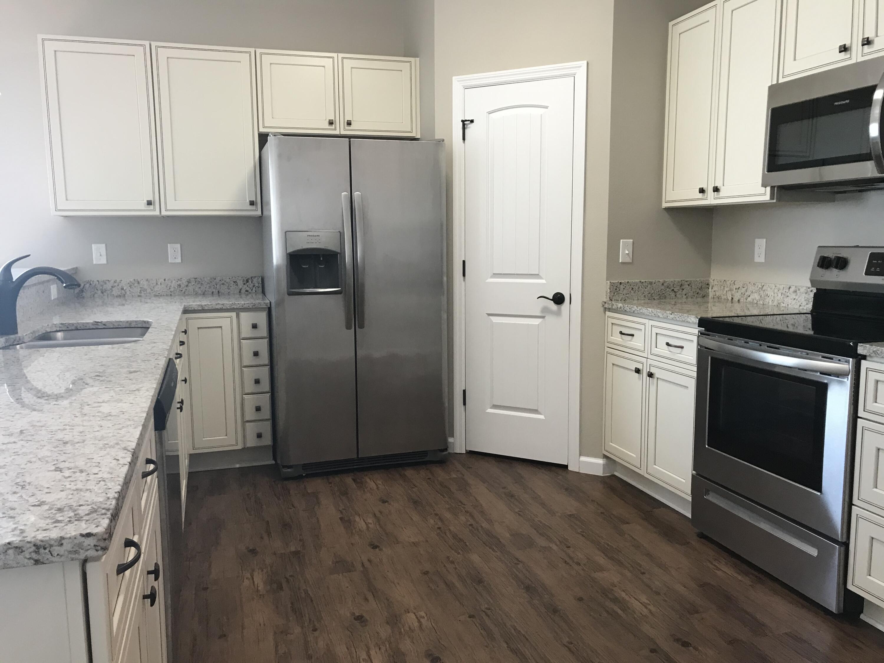 240 Dixie Street Crestview, FL 32536 - Photo 3 of 20 a kitchen with a sink stove and refrigerator