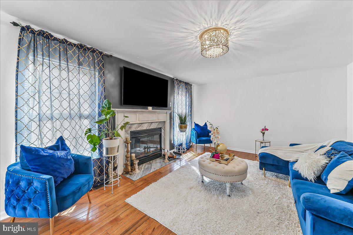 9 Corralberry Road Newark, DE 19702 - Photo 12 of 37 a living room with furniture a fireplace and a flat screen tv