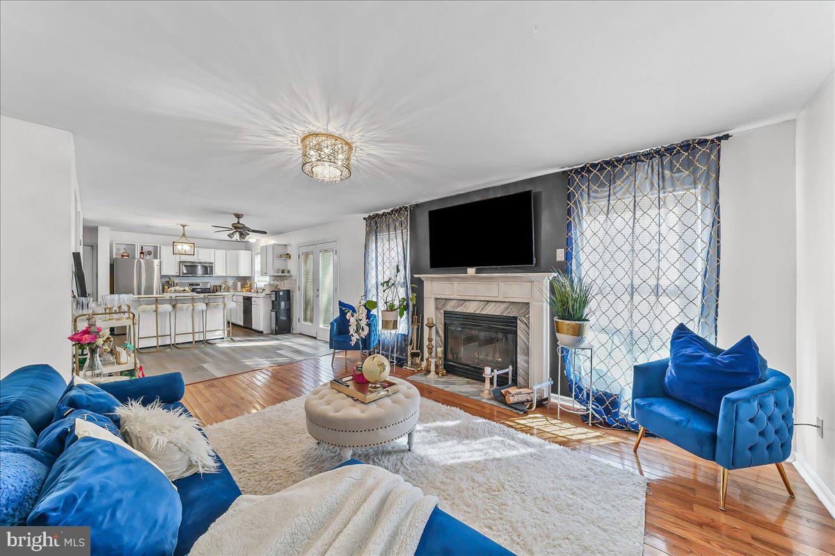 9 Corralberry Road Newark, DE 19702 - Photo 13 of 37 a living room with furniture a flat screen tv and a fireplace