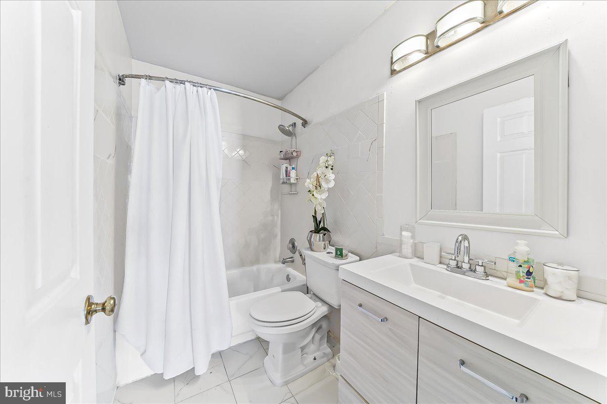 9 Corralberry Road Newark, DE 19702 - Photo 21 of 37 a bathroom with a granite countertop sink a toilet and a mirror