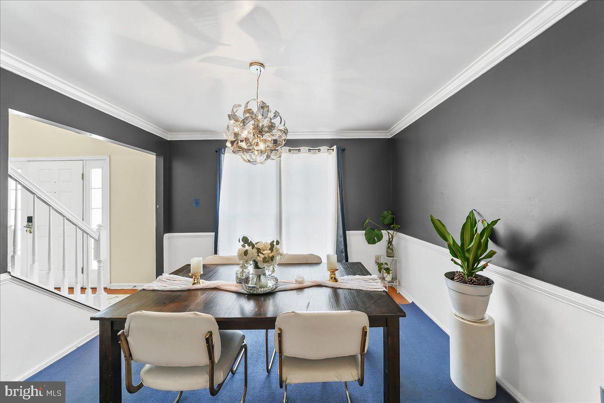 9 Corralberry Road Newark, DE 19702 - Photo 6 of 37 a view of a dining room with furniture a chandelier and wooden floor