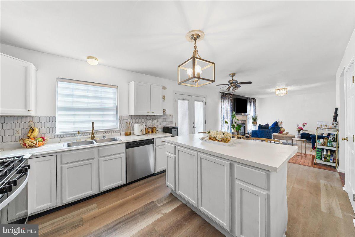 9 Corralberry Road Newark, DE 19702 - Photo 7 of 37 a kitchen with stainless steel appliances kitchen island a sink a stove and white cabinets