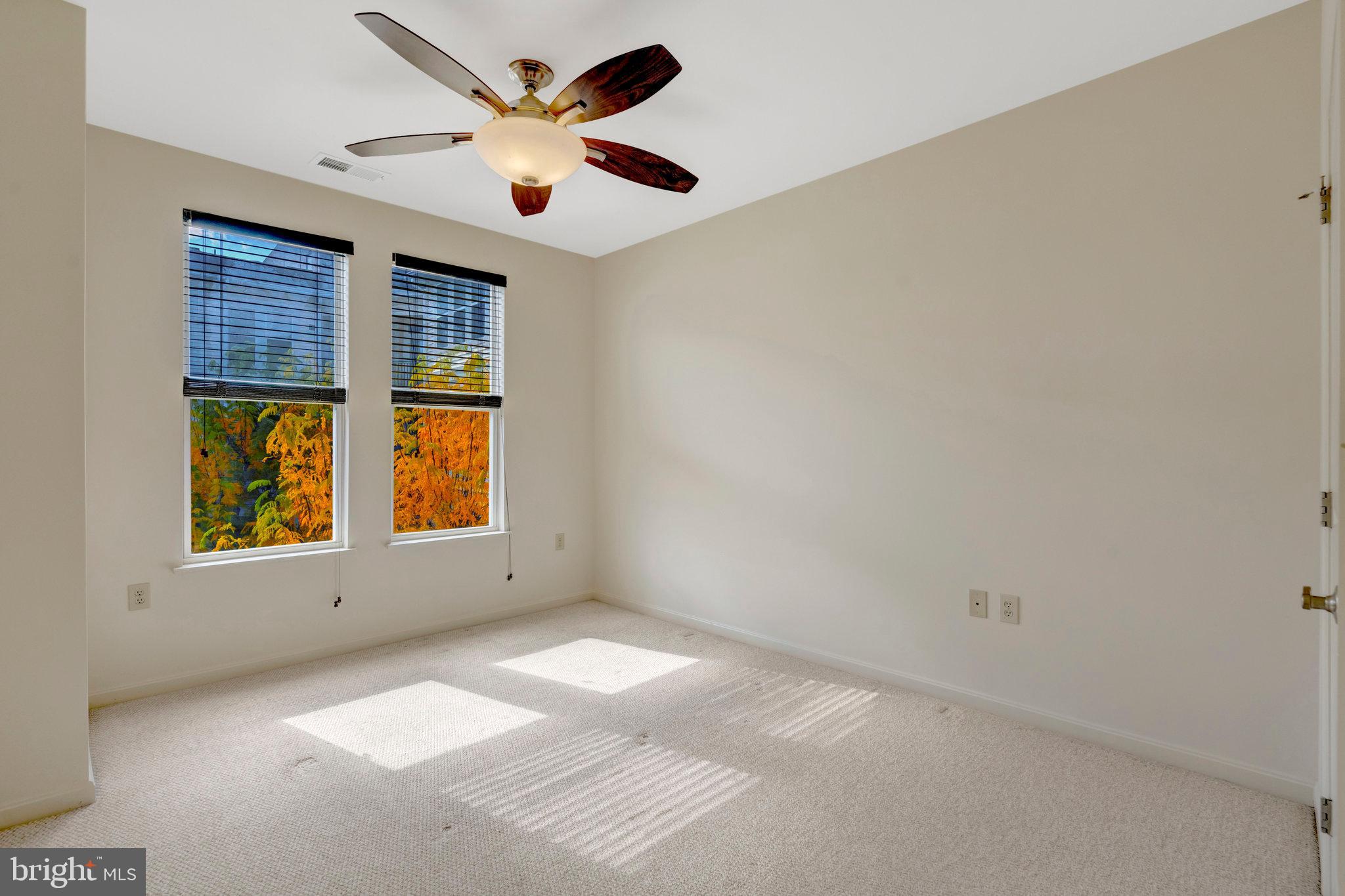 2665 Prosperity Avenue, Unit 345 Fairfax, VA 22031 - Photo 12 of 33 an empty room with windows and ceiling fan