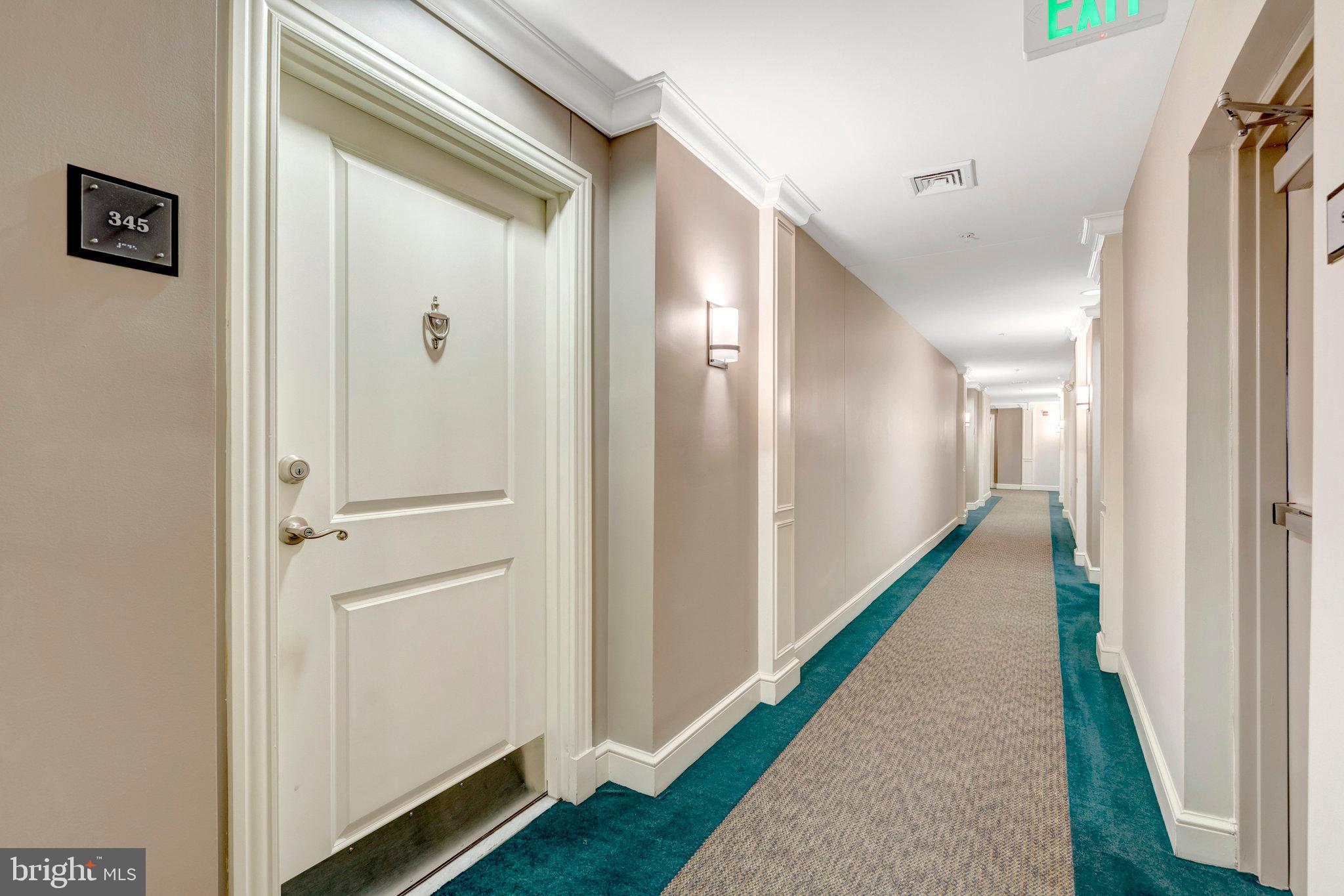 2665 Prosperity Avenue, Unit 345 Fairfax, VA 22031 - Photo 3 of 33 a view of a hallway with wooden floor and staircase