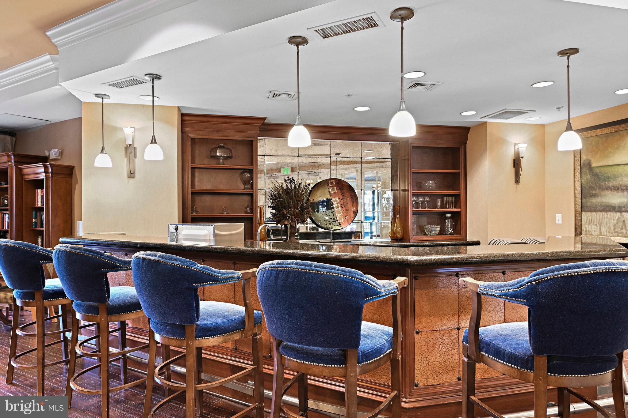 2665 Prosperity Avenue, Unit 345 Fairfax, VA 22031 - Photo 31 of 33 a kitchen with stainless steel appliances granite countertop a sink a stove a dining table and chairs