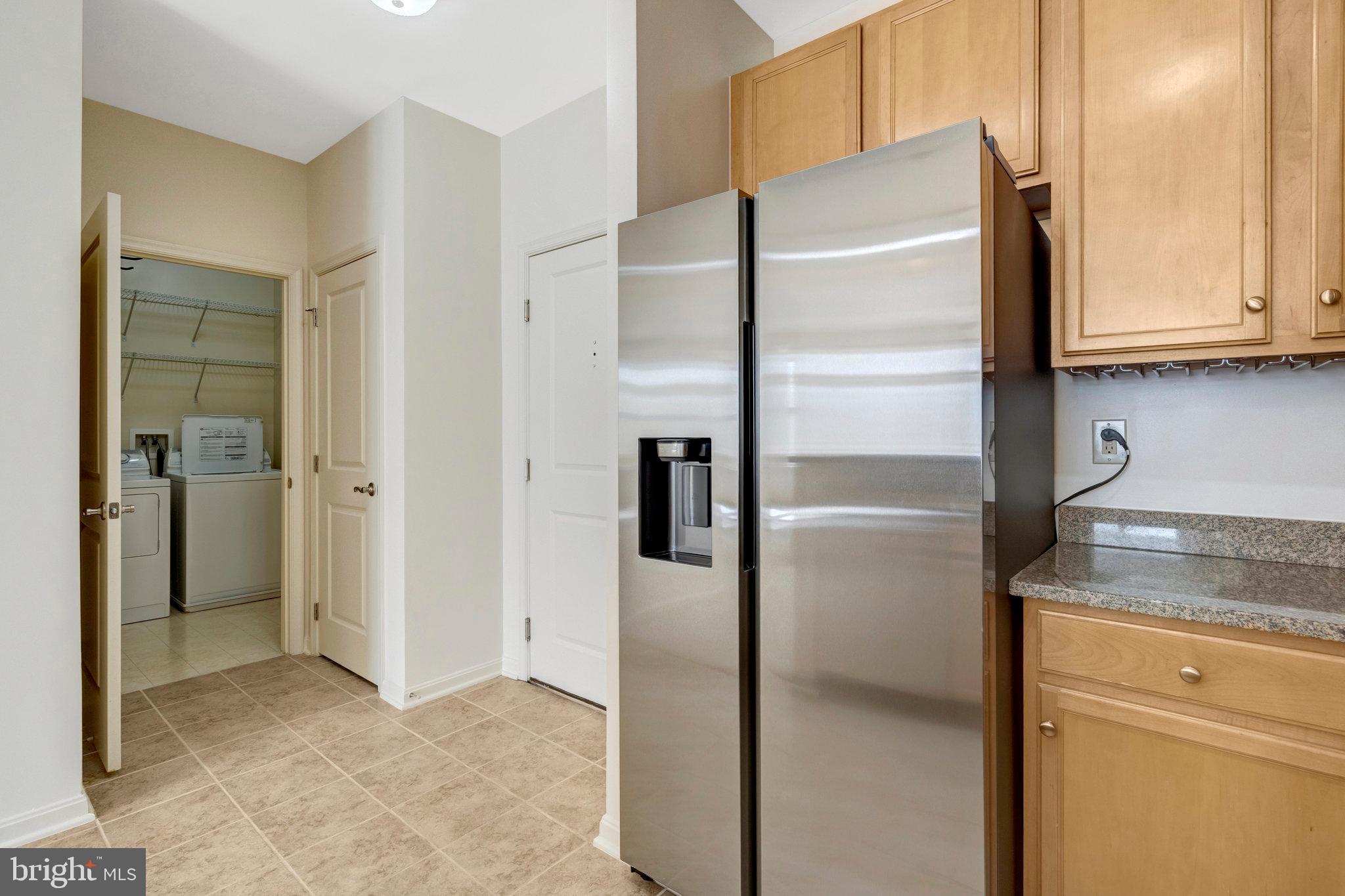 2665 Prosperity Avenue, Unit 345 Fairfax, VA 22031 - Photo 7 of 33 a metallic refrigerator freezer sitting in a kitchen