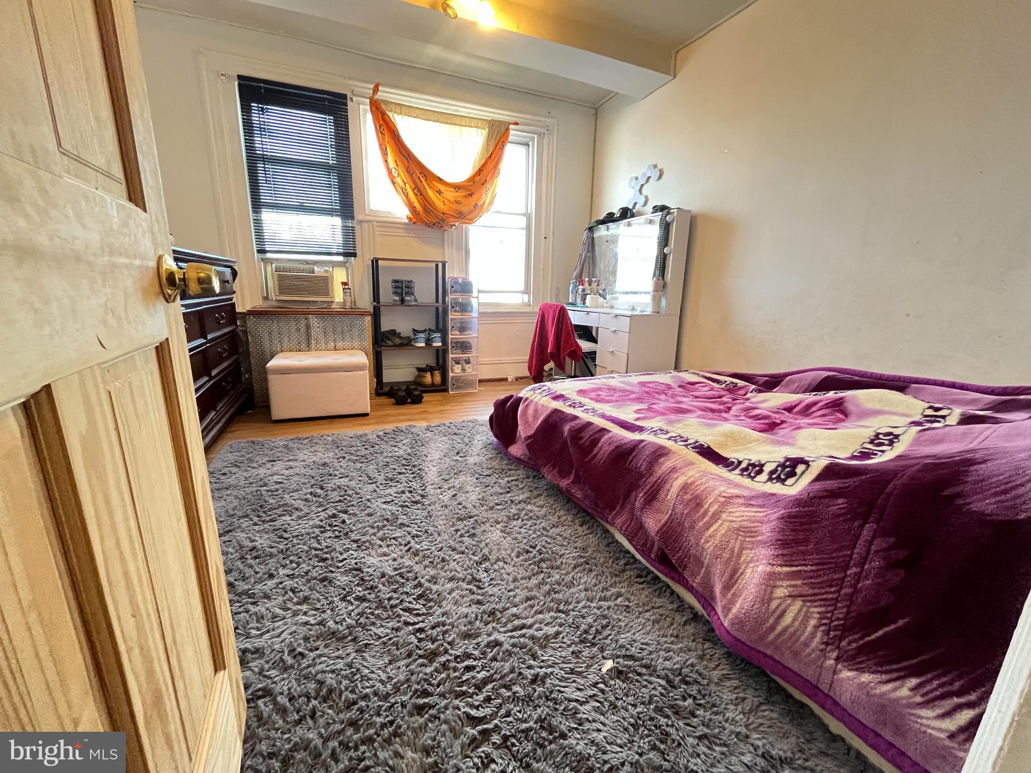 5726 Old 2nd Street Philadelphia, PA 19120 - Photo 9 of 21 a bedroom with a bed flat screen tv and a large window