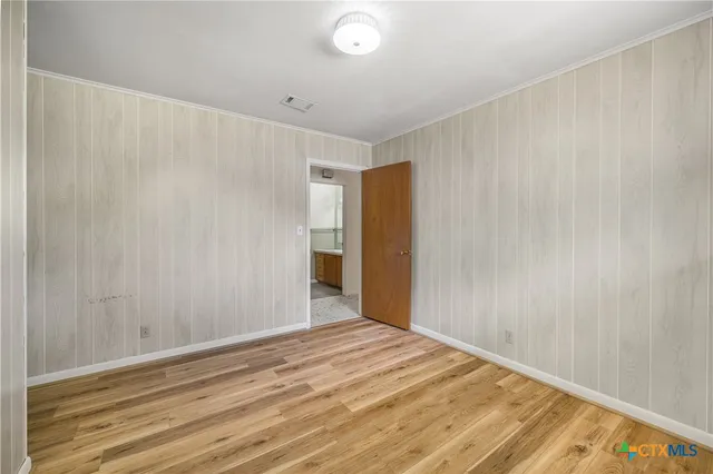 a view of a room with wooden floor