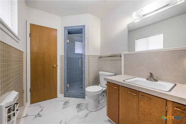 a bathroom with a sink toilet and shower
