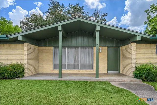 a side view of a house with a garage