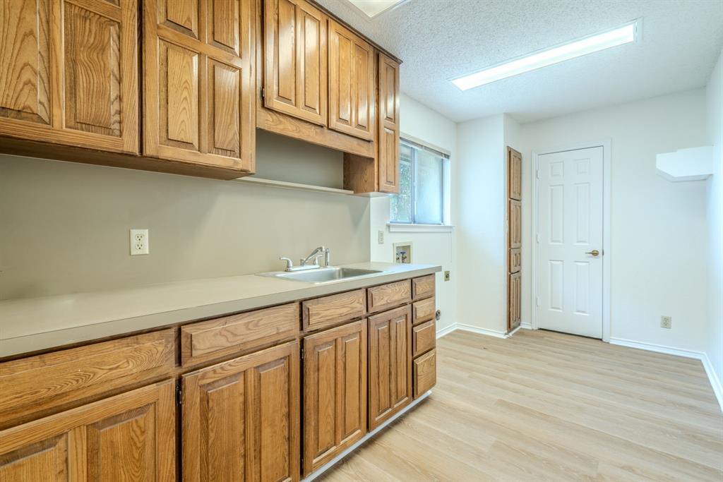 4501 Ridge North Road Fort Worth, TX 76126 - Photo 32 of 39 Utility room with cabinets and sink