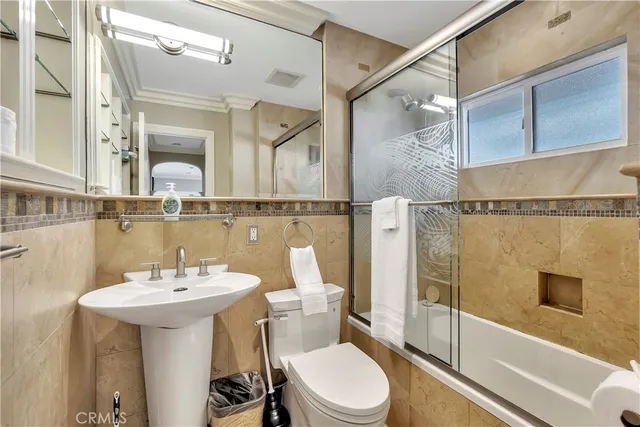 a kitchen with granite countertop a sink stainless steel appliances and cabinets