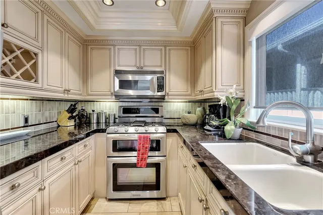 a kitchen with stainless steel appliances granite countertop a stove sink microwave and cabinets
