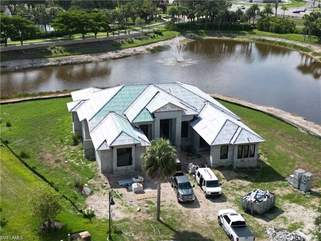 an aerial view of a house with lake view