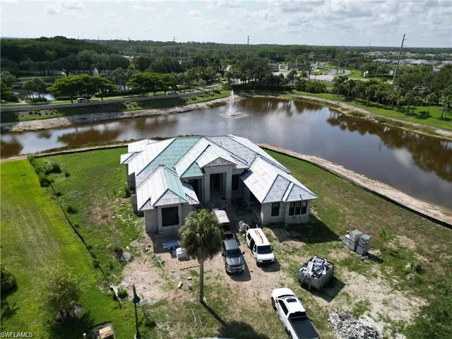 an aerial view of a house with outdoor space and lake view
