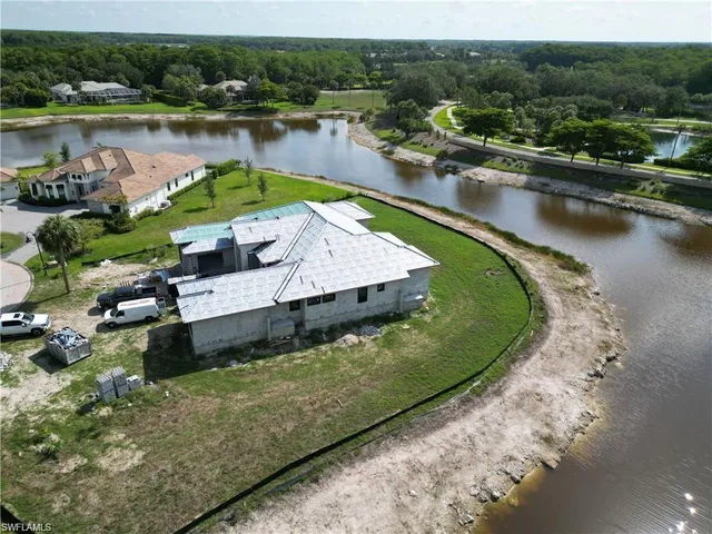 an aerial view of a house with lake view