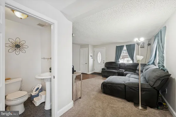 a living room with furniture and a lamp
