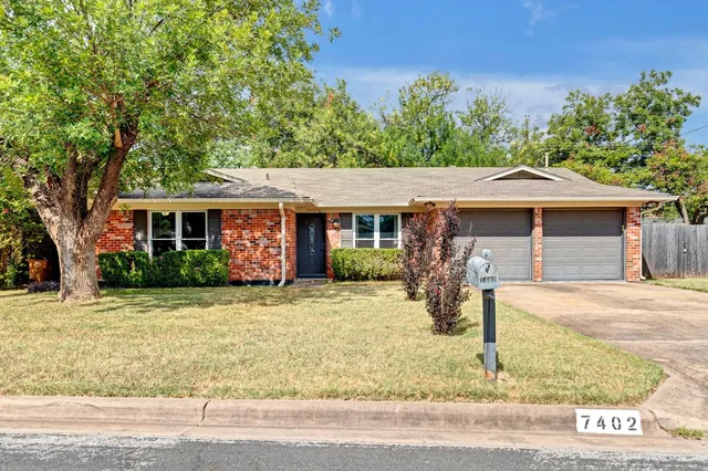 a front view of a house with porch and yard