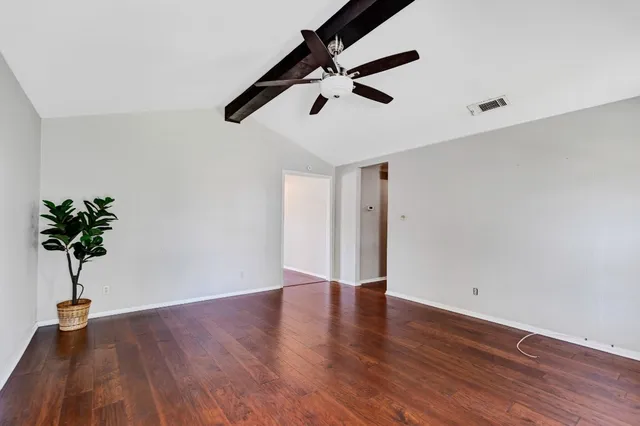 a view of room with wooden floor and potted plant