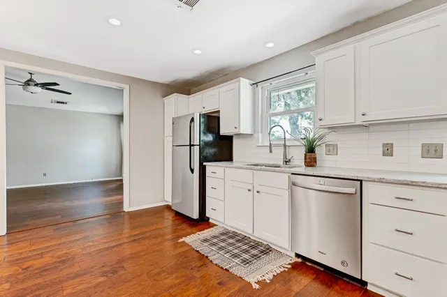 a kitchen with stainless steel appliances a refrigerator sink and microwave