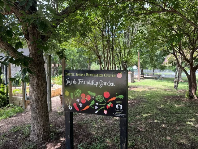 a view of a street with large trees