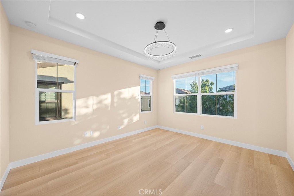 143 Rodeo Irvine, CA 92602 - Photo 26 of 37 a view of an empty room with wooden floor and a window