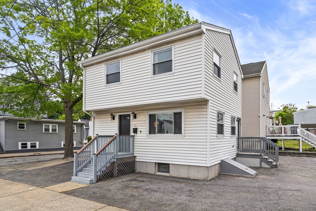 23 Logan Street Lynn, MA 01902 - Photo 1 of 27 a view of a house with a backyard