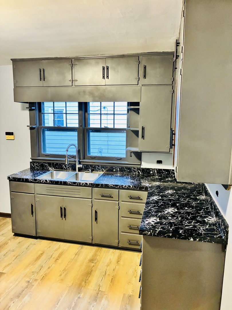14506 Clinton Street Harvey, IL 60426 - Photo 5 of 11 a kitchen with granite countertop a stove and a sink