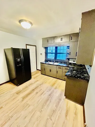 a kitchen with a refrigerator and a stove