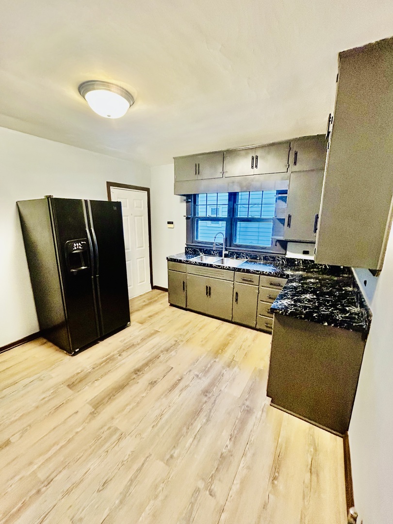14506 Clinton Street Harvey, IL 60426 - Photo 6 of 11 a kitchen with a refrigerator and a stove