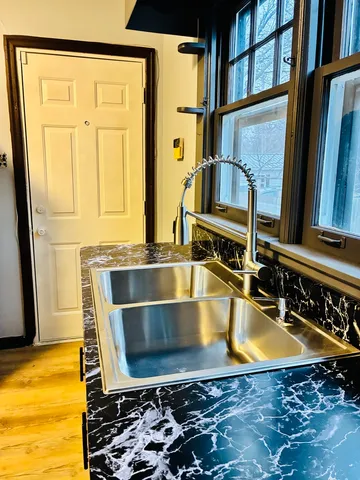 a view of a kitchen with a sink and a stove top oven