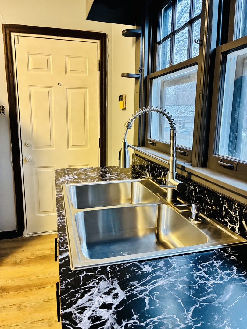 14506 Clinton Street Harvey, IL 60426 - Photo 7 of 11 a view of a kitchen with a sink and a stove top oven