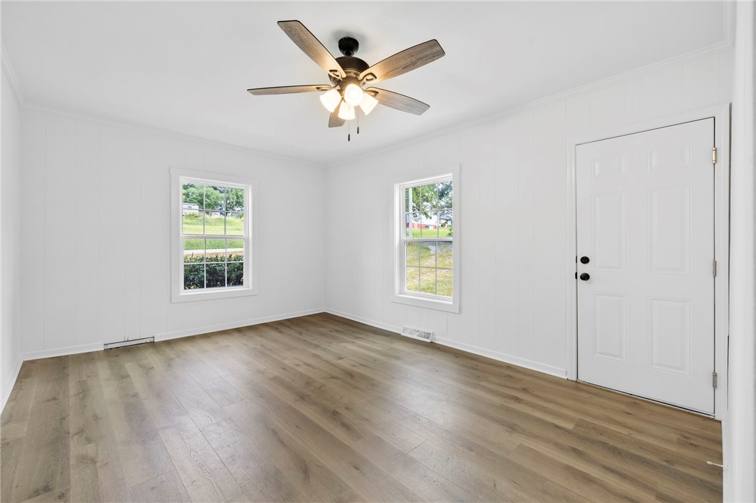 201 South 8th Street Easley, SC 29640 - Photo 15 of 28 Rich wood-inspired flooring pairs with clean paneled walls in this versatile living space.