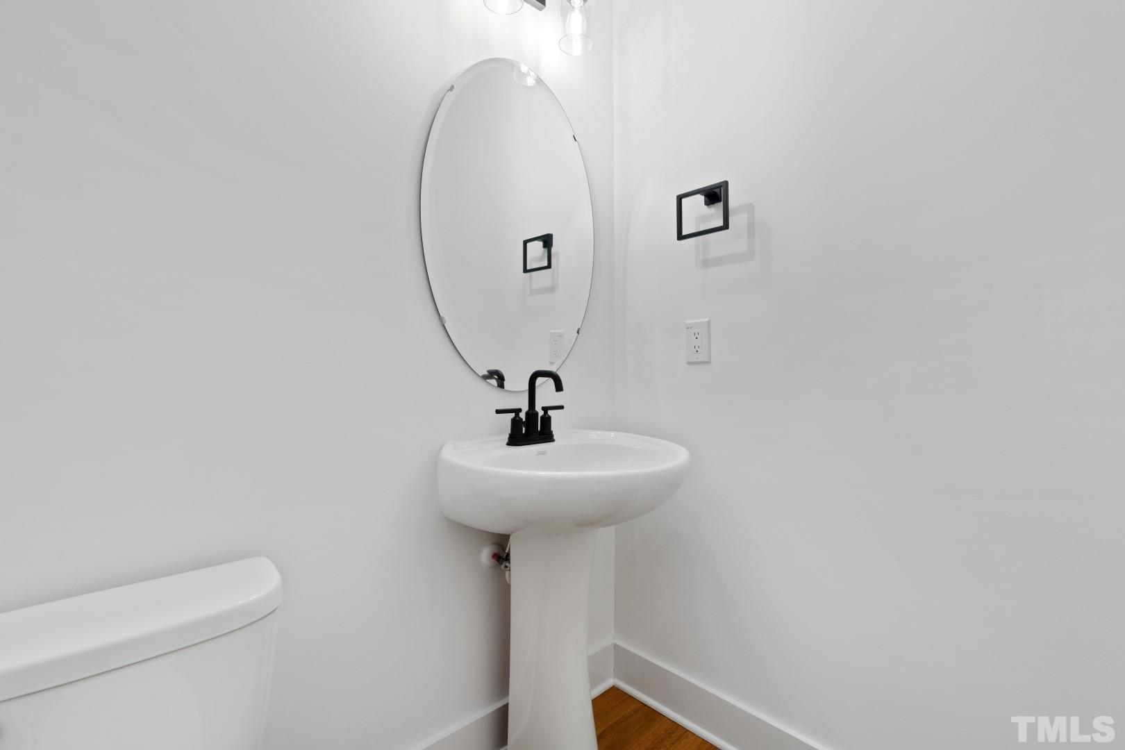 6118 Fox Road Raleigh, NC 27616 - Photo 20 of 32 a bathroom with a sink a toilet and a mirror