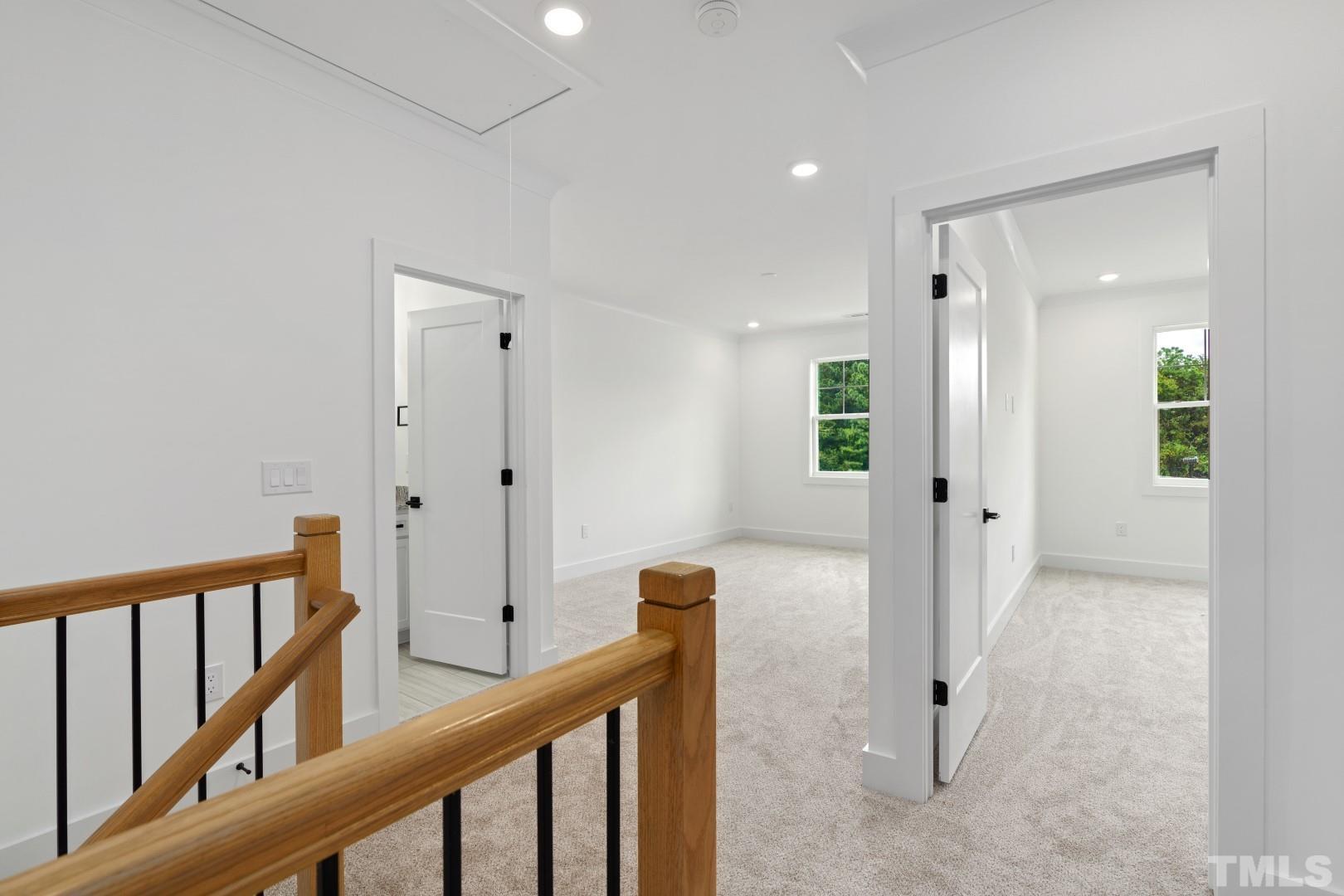 6118 Fox Road Raleigh, NC 27616 - Photo 27 of 32 a view of a hallway with wooden floor and staircase