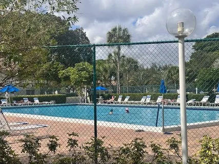 a backyard of a house with a table and chairs