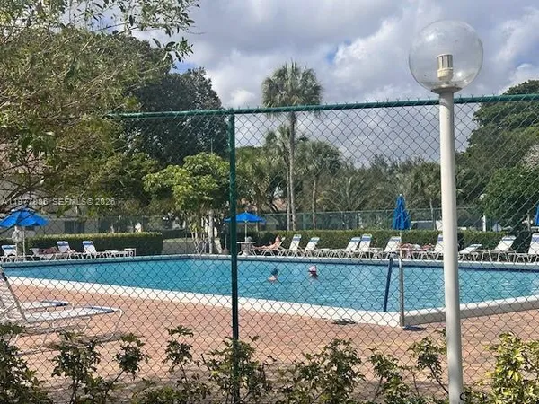a backyard of a house with a table and chairs