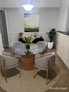 a dining room with furniture and wooden floor