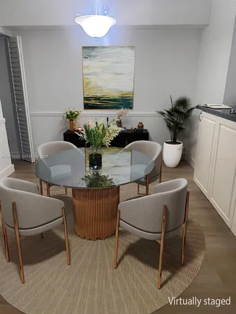 a dining room with furniture and wooden floor