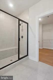 a view of walk in closet with clothes