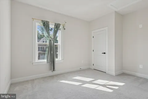 a bathroom with a double vanity sink a toilet a mirror and shower