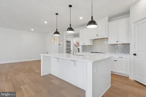 a view of a kitchen with a sink a window and cabinets