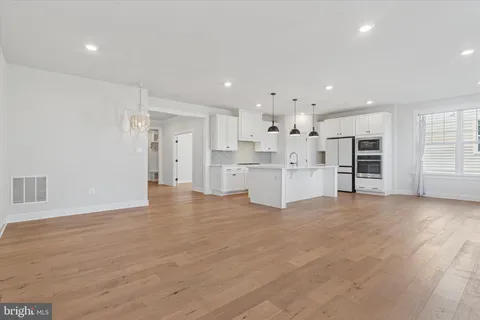 a view of a kitchen with refrigerator and a sink